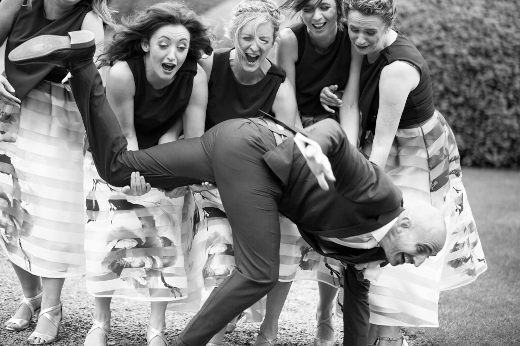 Bridesmaids dropping the groom