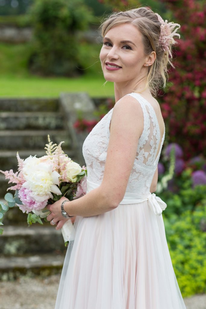 Newly wed with bouquet. Photography by So Studios, Essex