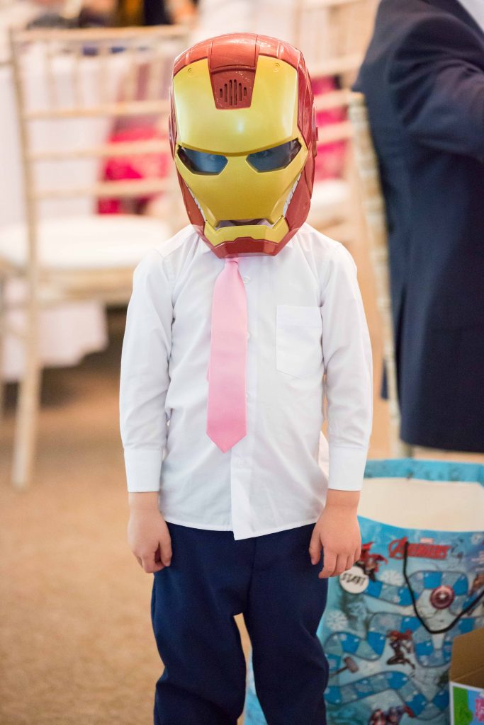 Boy in Iron Man mask at wedding reception