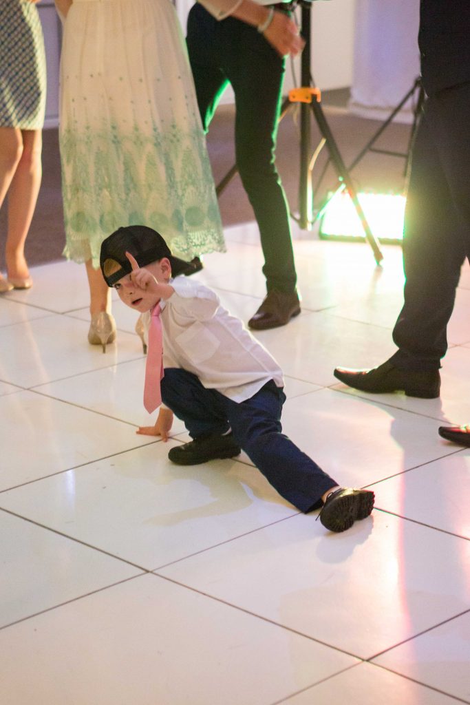 3 year old boy break dancing at wedding